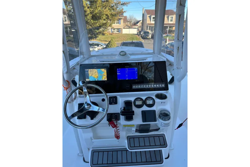 Slide: The Image of 2022 Tidewater 210 CC Adventure boat dashboard with navigation screens and controls. - 7