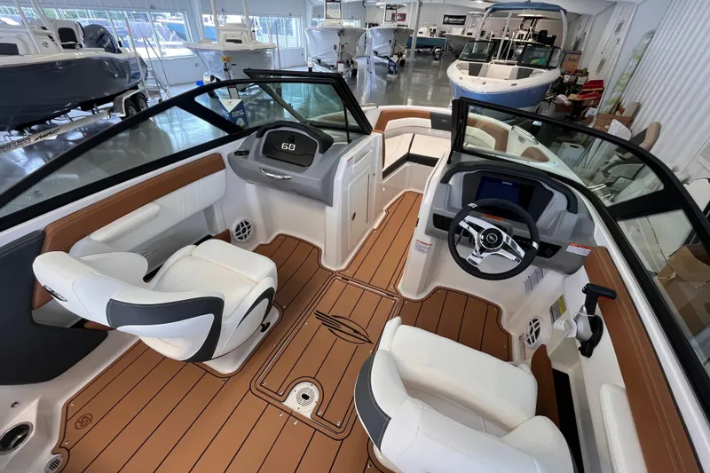 Slide: The Image of 2025 Chaparral 21 SSi OB boat interior with modern seating and steering wheel. - 6