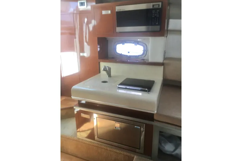 Slide: The Image of Interior of 2010 Sea Ray 260 Sundancer with kitchenette and microwave. - 18
