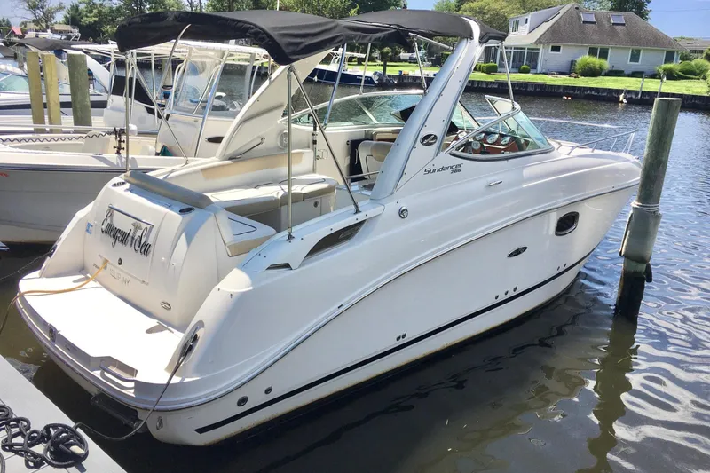 Slide: The Image of 2010 Sea Ray 260 Sundancer boat docked in a marina. - 2