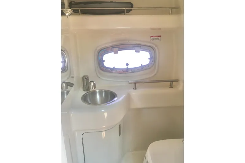Slide: The Image of Interior of 2010 Sea Ray 260 Sundancer boat with sink and porthole window. - 23