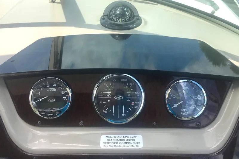 Slide: The Image of Dashboard of a 2010 Sea Ray 260 Sundancer boat with gauges and compass. - 7