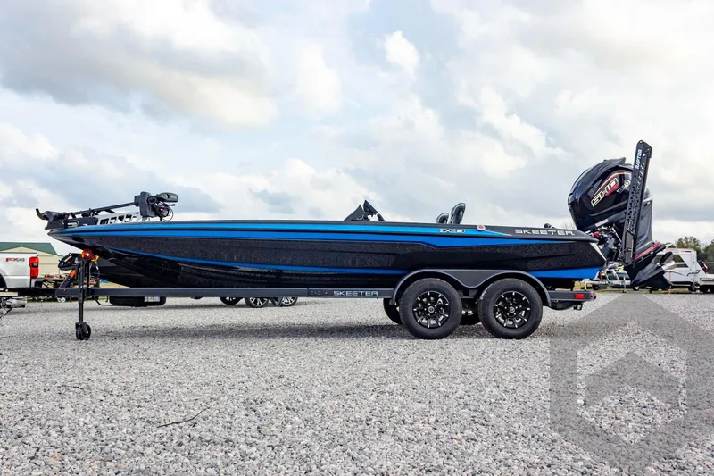 Slide: The Image of 2026 Skeeter ZXE21 boat on trailer, side view, cloudy sky background. - 15