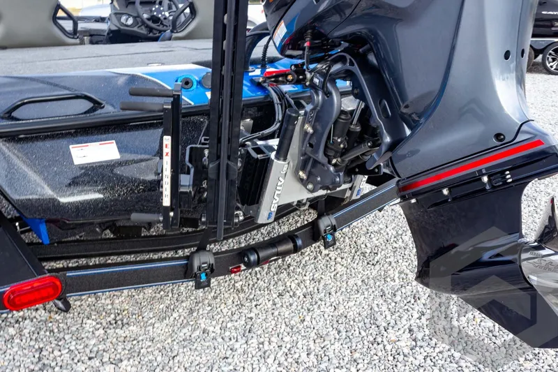Slide: The Image of 2026 Skeeter ZXE21 boat engine and motor detail on gravel surface. - 23