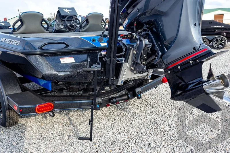 Slide: The Image of 2026 Skeeter ZXE21 boat with powerful outboard motor on gravel surface. - 24