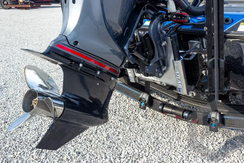 Slide: The Image of 2026 Skeeter ZXE21 boat motor and propeller on gravel surface. - 26