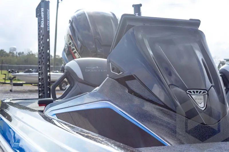 Slide: The Image of 2026 Skeeter ZXE21 boat with sleek design and advanced features, parked outdoors. - 29