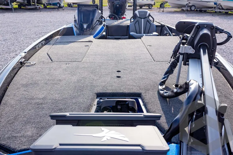 Slide: The Image of 2026 Skeeter ZXE21 boat deck with seating and equipment, parked on gravel. - 33