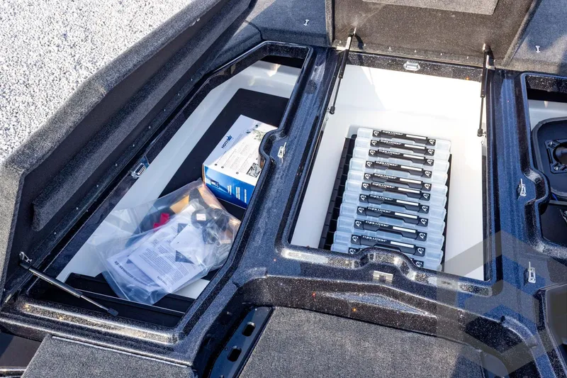 Slide: The Image of Storage compartment of 2026 Skeeter ZXE21 boat with organized tackle boxes and accessories. - 36
