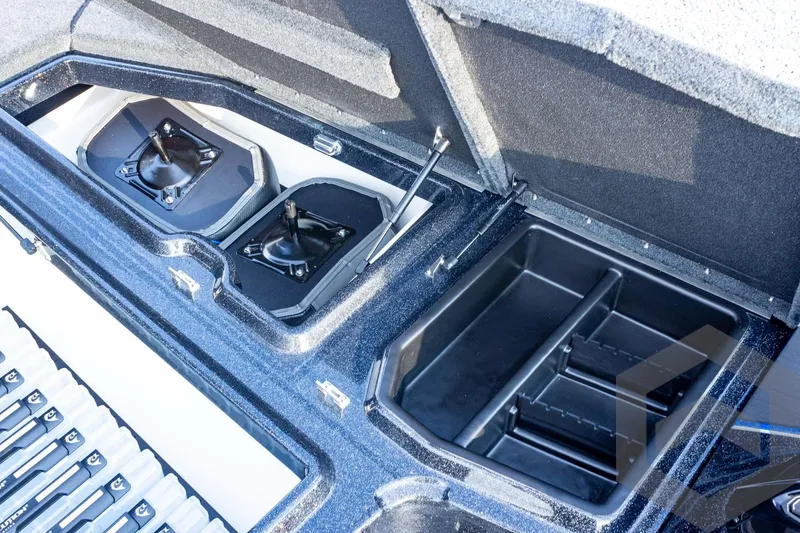 Slide: The Image of 2026 Skeeter ZXE21 boat storage compartments with open lids, showcasing interior design. - 37