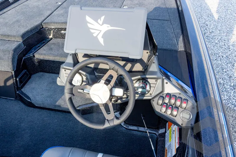 Slide: The Image of 2026 Skeeter ZXE21 boat dashboard with steering wheel and control panel. - 49