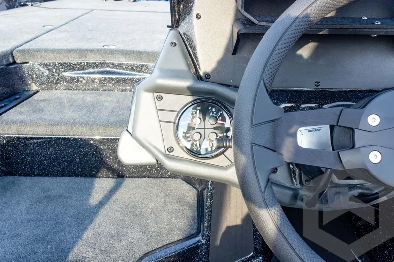 Slide: The Image of 2026 Skeeter ZXE21 boat dashboard with steering wheel and instrument panel. - 52