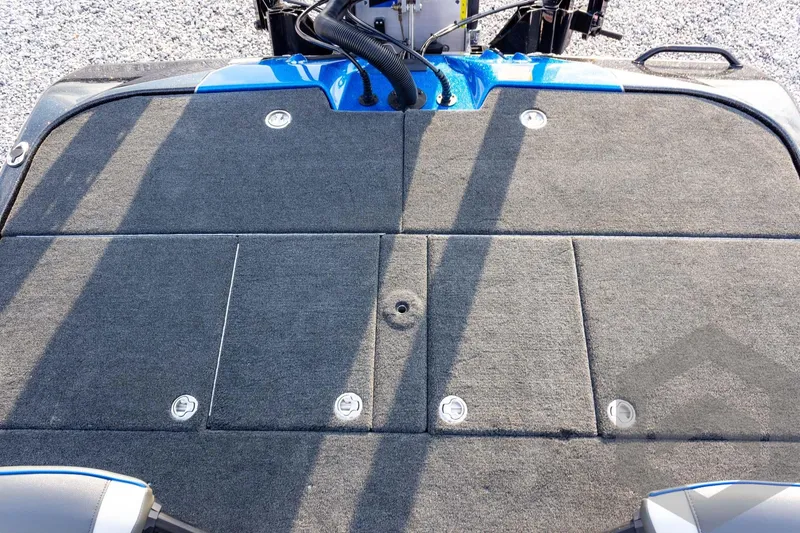 Slide: The Image of 2026 Skeeter ZXE21 boat deck with gray carpet and storage compartments. - 54