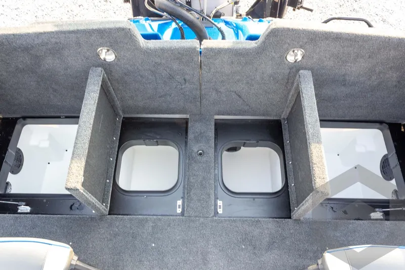 Slide: The Image of 2026 Skeeter ZXE21 boat storage compartments with open lids, showcasing interior space. - 55