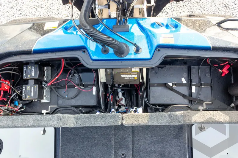 Slide: The Image of 2026 Skeeter ZXE21 boat battery compartment with wiring and components. - 56