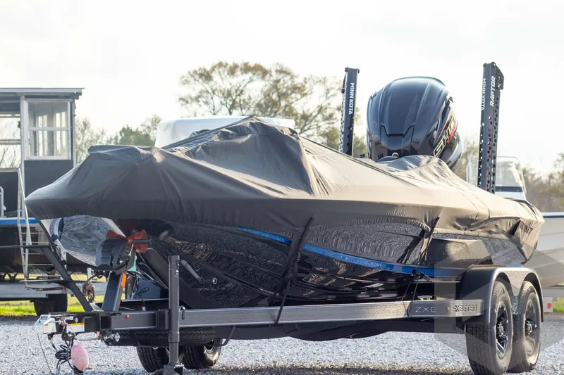 Slide: The Image of 2026 Skeeter ZXE21 boat covered on trailer, featuring sleek design and powerful engine. - 57
