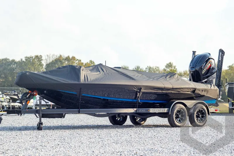 Slide: The Image of 2026 Skeeter ZXE21 boat covered on trailer, parked outdoors. - 58