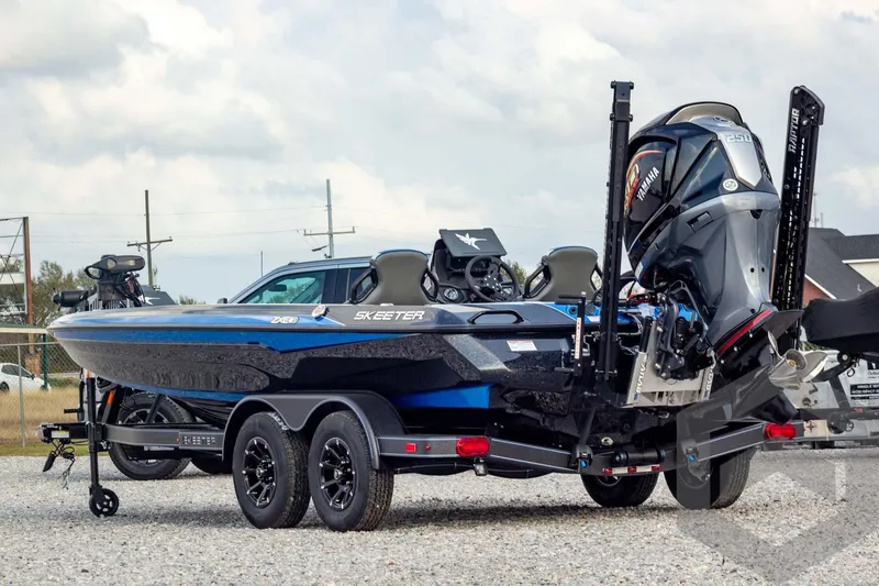 Slide: The Image of 2026 Skeeter ZXE21 boat with Yamaha engine on a trailer, parked outdoors. - 6