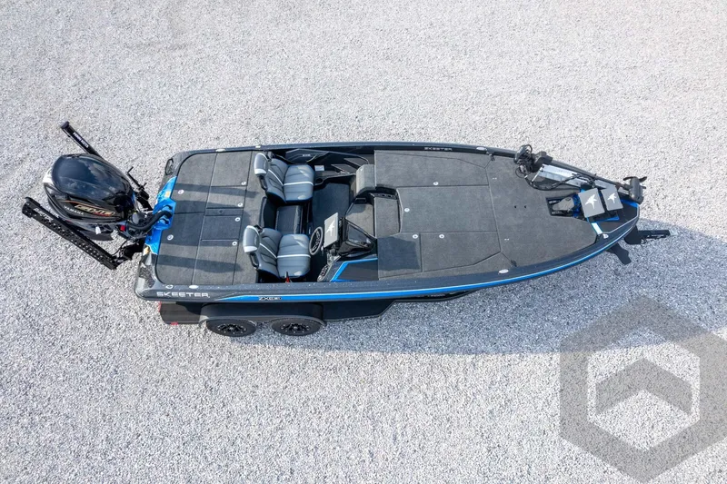 Slide: The Image of 2026 Skeeter ZXE21 boat, aerial view, featuring sleek design and modern seating on gravel surface. - 65