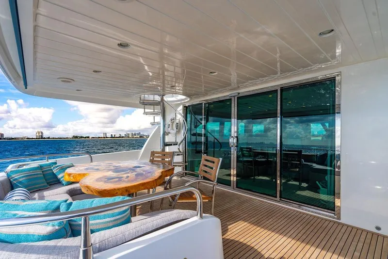 Slide: The Image of Luxurious Lanzarote Ventuno 73 yacht deck with wooden table, ocean view, and comfortable seating. - 17