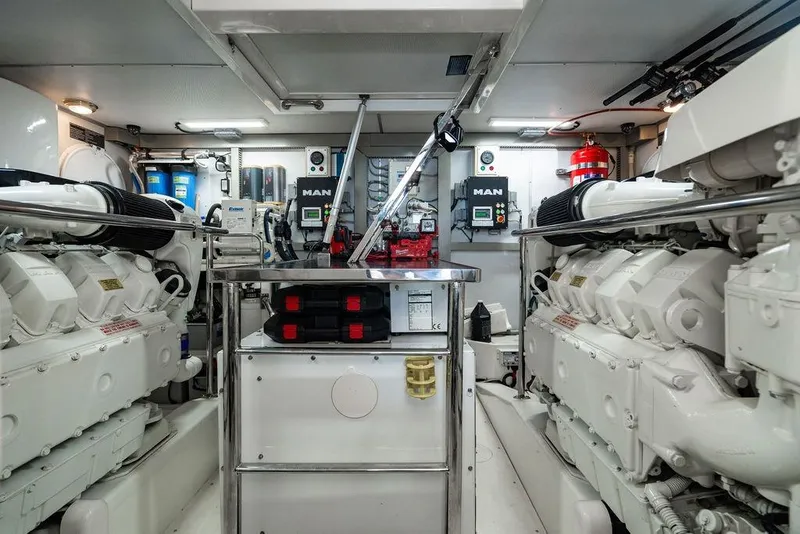 Slide: The Image of Engine room of 2013 Lanzarote Ventuno 73 yacht, featuring dual MAN engines and control systems. - 86