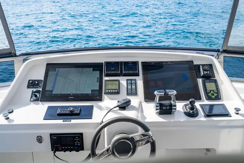 Slide: The Image of Control panel of a 2013 Lanzarote Ventuno 73 yacht with navigation screens and steering wheel. - 29