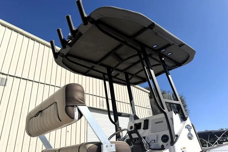 Slide: The Image of 2024 Yamaha Boats 222 FSH Sport with T-top and console, outdoor view. - 13