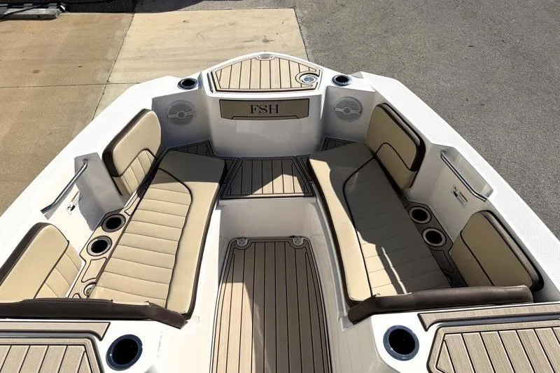 Slide: The Image of 2024 Yamaha Boats 222 FSH Sport interior with beige seating and cup holders. - 15