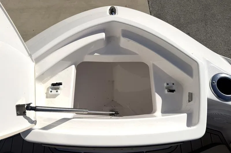 Slide: The Image of Open storage compartment on 2024 Yamaha Boats 222 FSH Sport. - 16