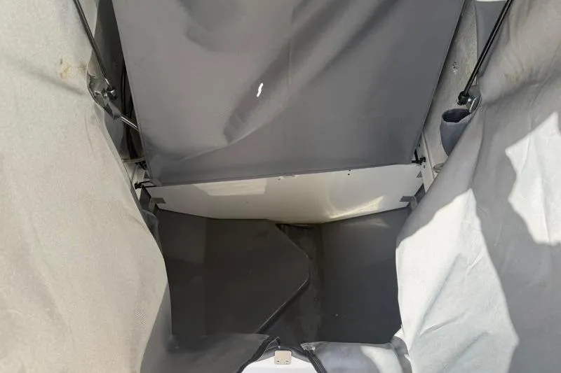 Slide: The Image of 2024 Yamaha Boats 222 FSH Sport interior storage area with protective cover. - 20