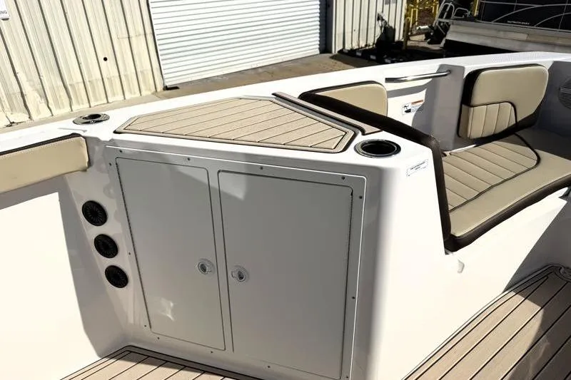 Slide: The Image of 2024 Yamaha Boats 222 FSH Sport interior with seating and storage compartments. - 21
