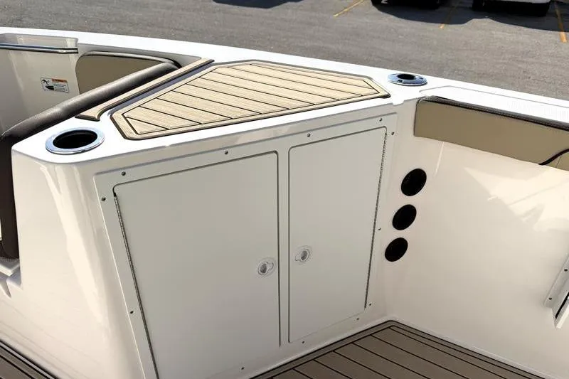 Slide: The Image of 2024 Yamaha Boats 222 FSH Sport interior with storage and cup holders. - 22