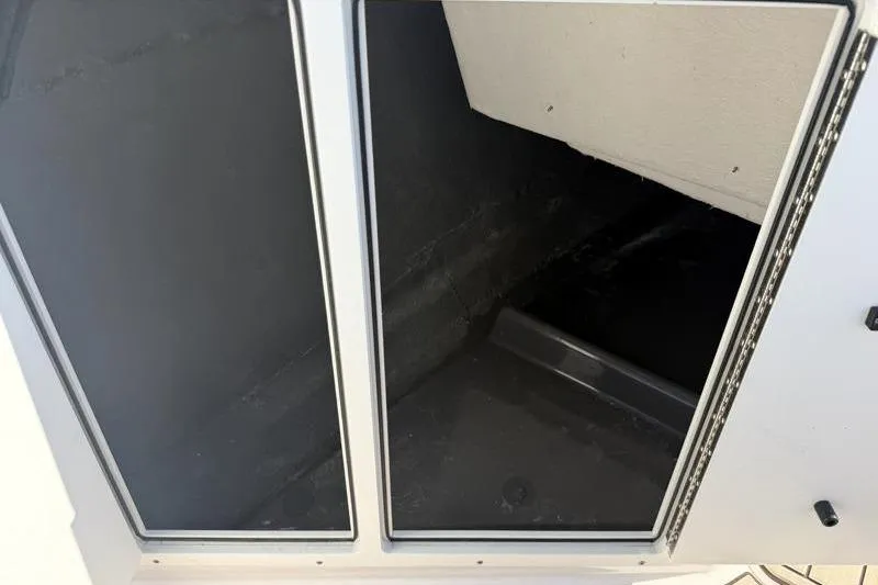 Slide: The Image of 2024 Yamaha Boats 222 FSH Sport storage compartment interior view. - 24