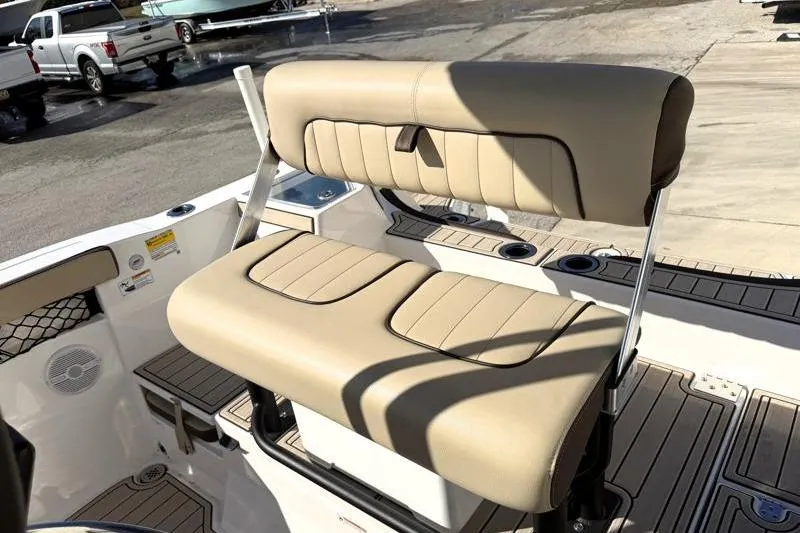 Slide: The Image of 2024 Yamaha Boats 222 FSH Sport interior seating with beige upholstery and cup holders. - 27