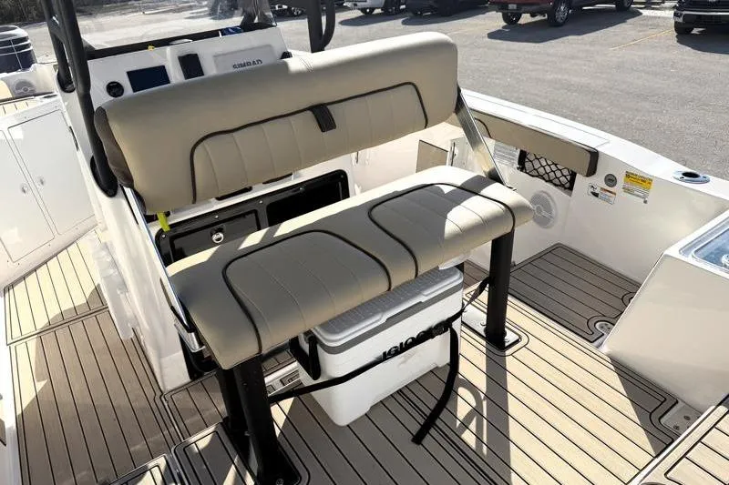 Slide: The Image of 2024 Yamaha Boats 222 FSH Sport interior with seating and cooler on deck. - 28