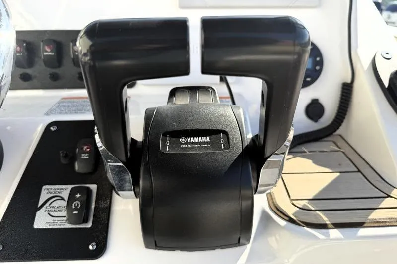 Slide: The Image of Close-up of 2024 Yamaha Boats 222 FSH Sport throttle controls on the dashboard. - 33