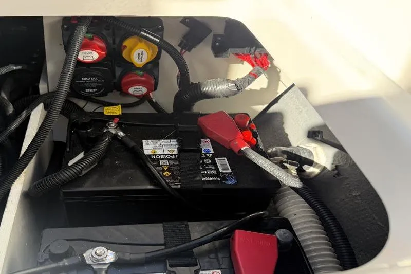 Slide: The Image of 2024 Yamaha Boats 222 FSH Sport battery compartment with wiring and connections. - 35