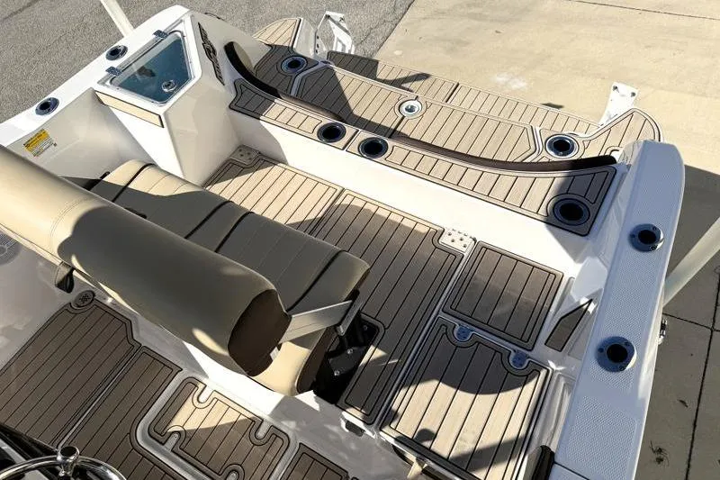 Slide: The Image of 2024 Yamaha Boats 222 FSH Sport interior with cushioned seating and rod holders. - 37