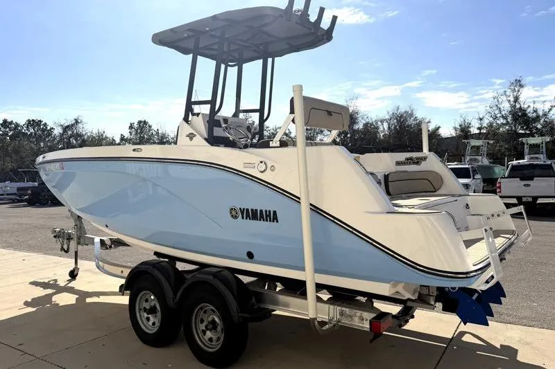 Slide: The Image of 2024 Yamaha Boats 222 FSH Sport on trailer, side view in outdoor setting. - 5