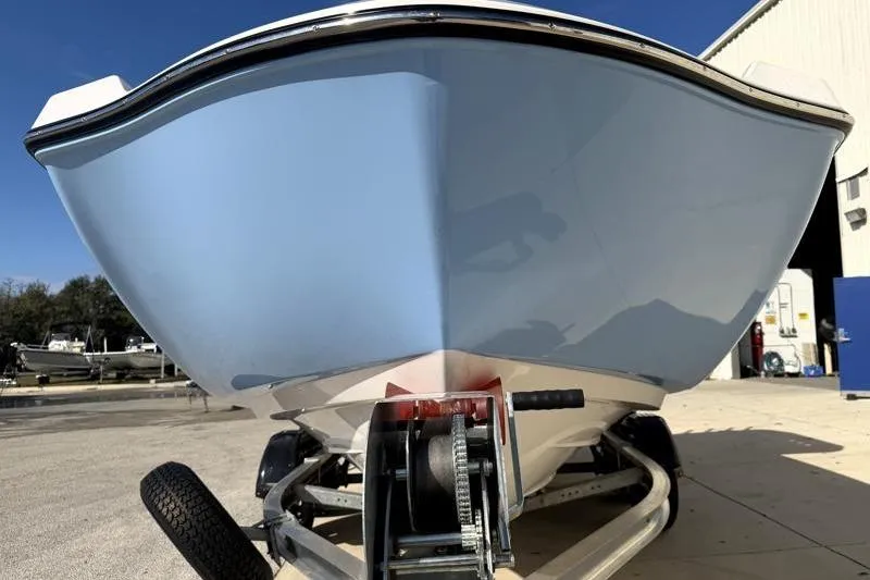 Slide: The Image of 2024 Yamaha Boats 222 FSH Sport on trailer, front view, light blue hull. - 7