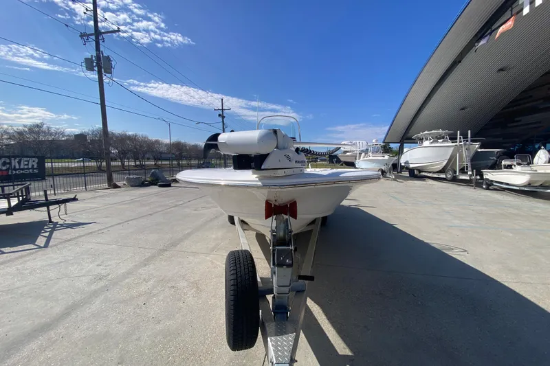 Slide: The Image of 2023 Tidewater 2410 Bay Max boat on trailer, displayed outdoors under clear blue sky. - 10