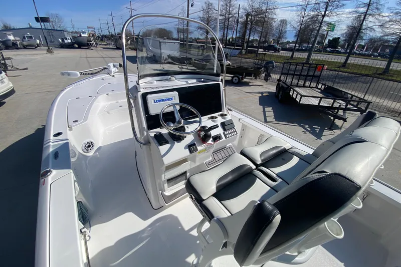 Slide: The Image of 2023 Tidewater 2410 Bay Max boat, spacious deck, sleek design, parked outdoors. - 14