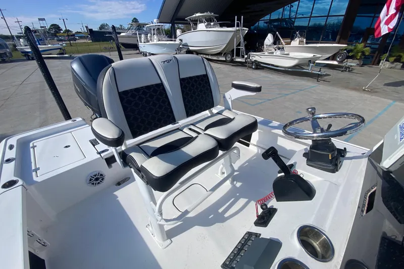 Slide: The Image of 2023 Tidewater 2410 Bay Max boat interior with seating and console, showcasing modern design. - 16