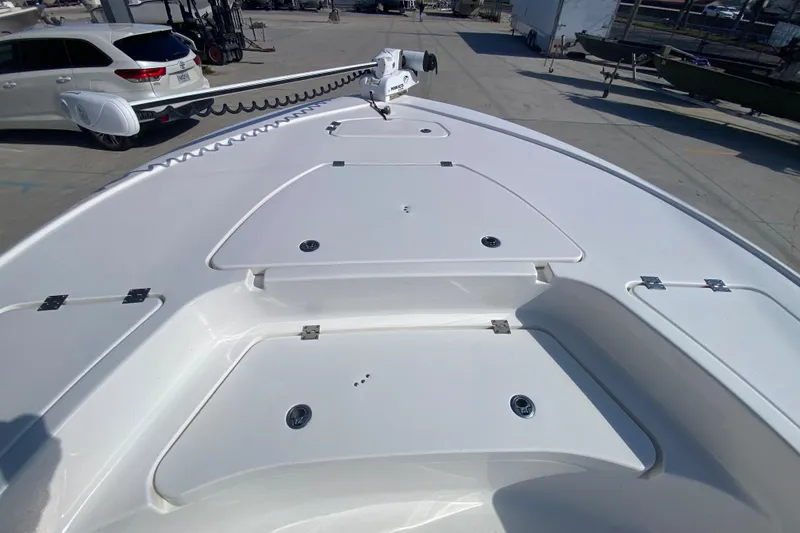 Slide: The Image of 2023 Tidewater 2410 Bay Max boat with Yamaha engine, spacious deck, and storage compartments. - 21