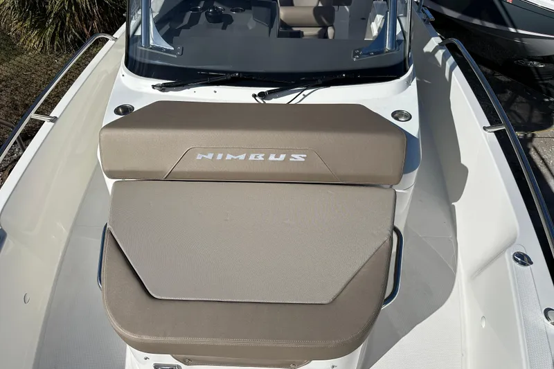 Slide: The Image of 2024 Nimbus T-8 boat with cushioned seating and sleek design. - 12