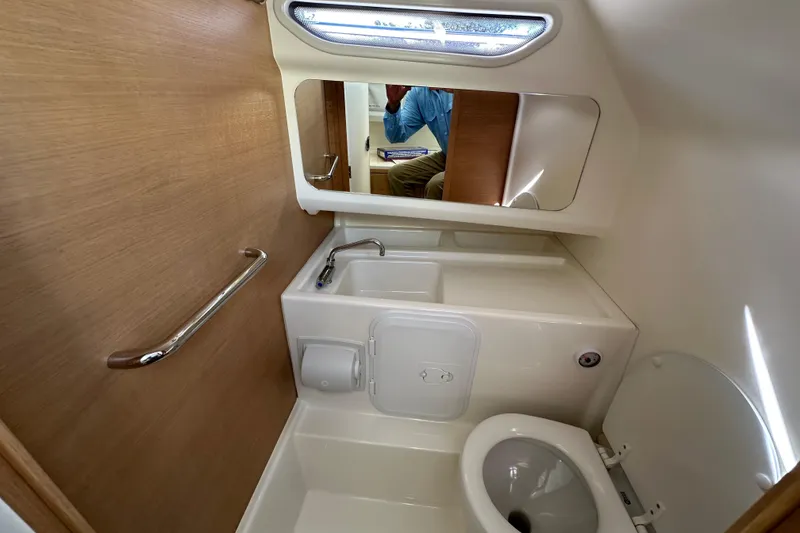 Slide: The Image of 2024 Nimbus T-8 boat bathroom with sink, mirror, and toilet. - 13