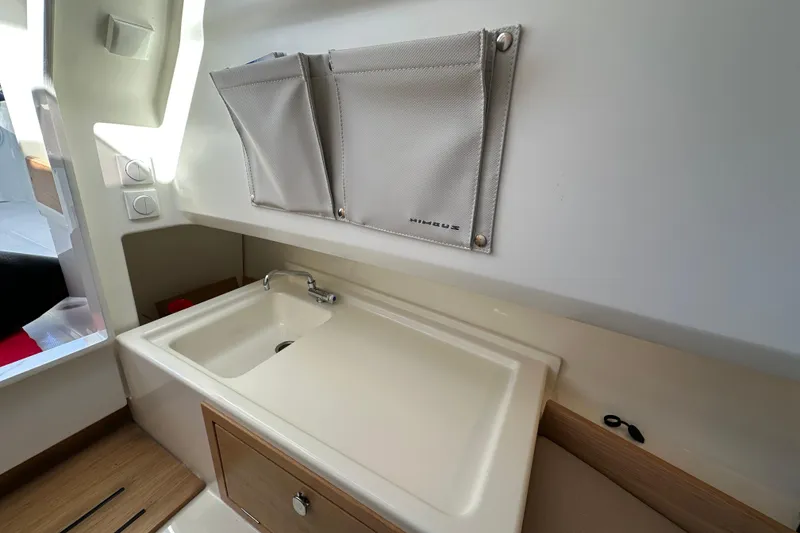 Slide: The Image of Modern kitchen sink area in 2024 Nimbus T-8 boat, featuring sleek design and storage. - 14