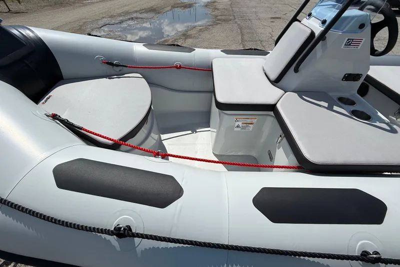 Slide: The Image of 2026 Zodiac Open 4.2 inflatable boat interior with seating and steering console. - 10