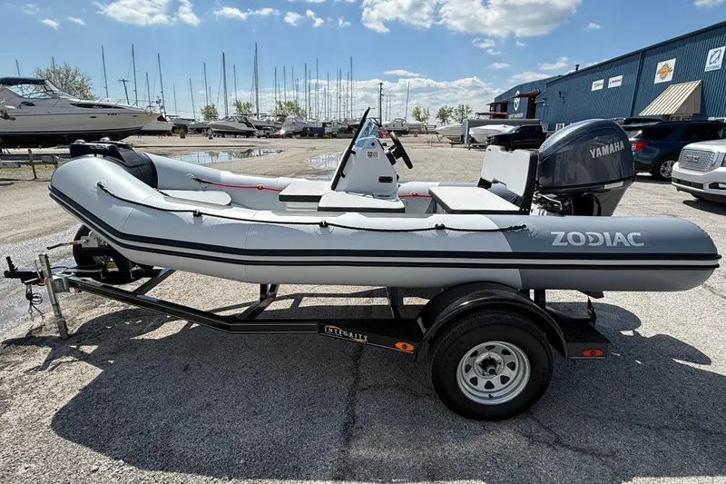 Slide: The Image of 2026 Zodiac Open 4.2 inflatable boat on trailer, featuring Yamaha outboard motor. - 3