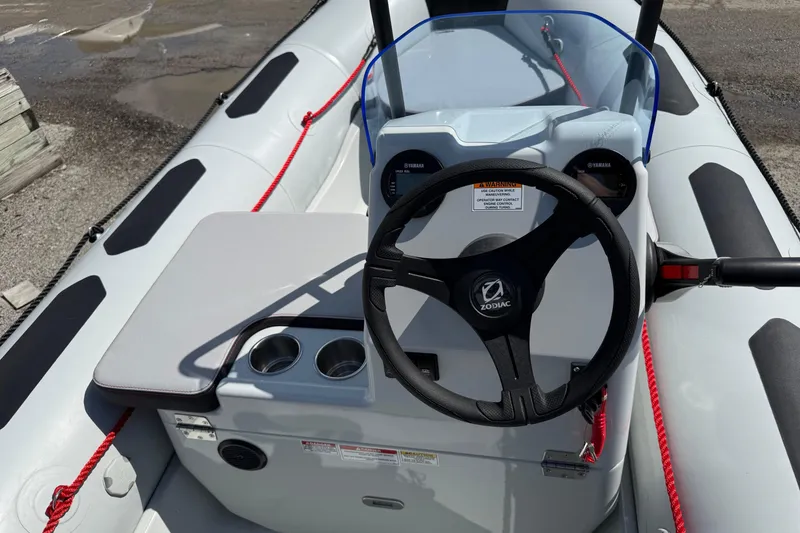 Slide: The Image of 2026 Zodiac Open 4.2 boat interior with steering wheel and dashboard controls. - 8